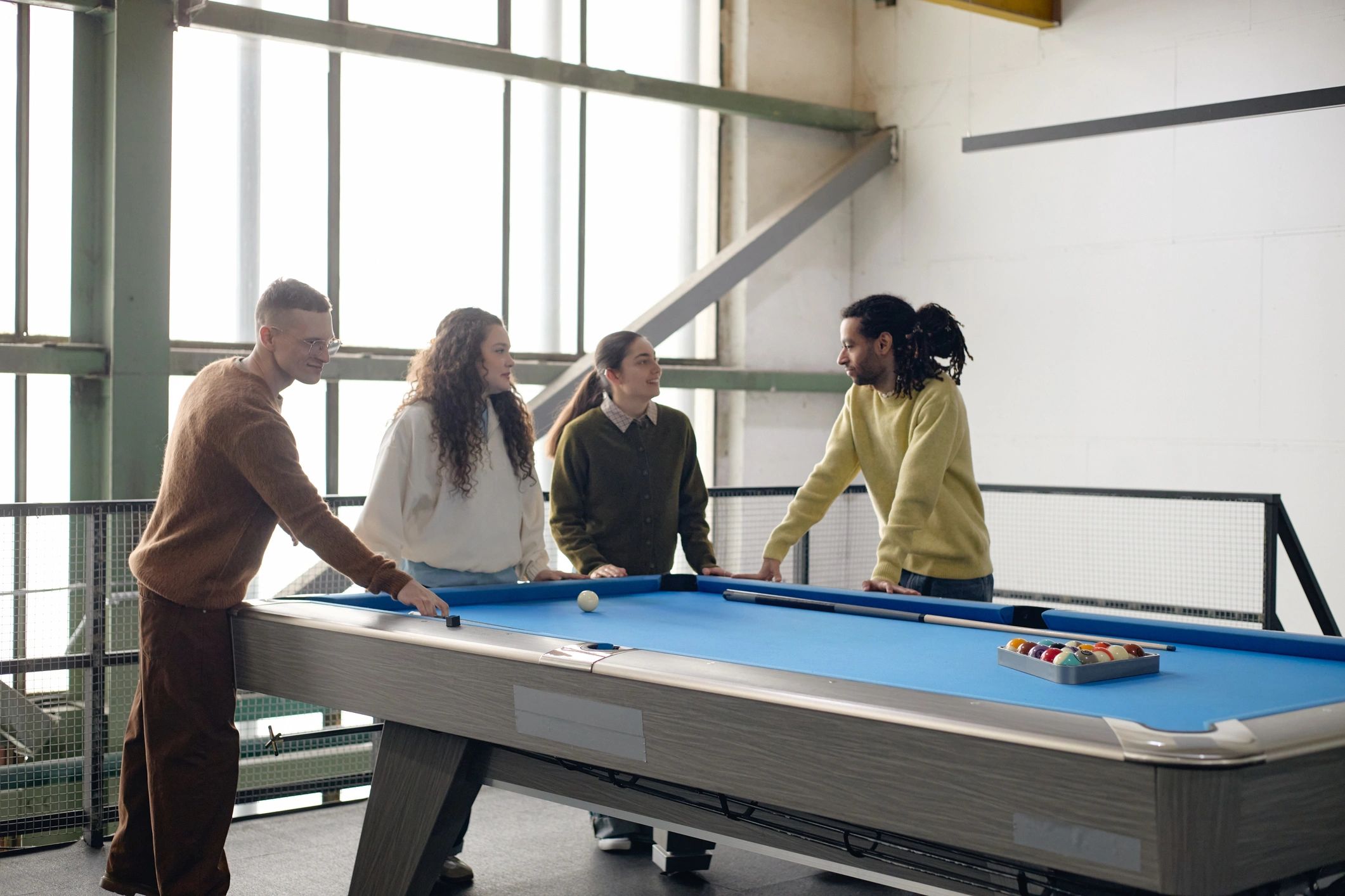 Group gathered around a gaming table representing teamwork and coordination