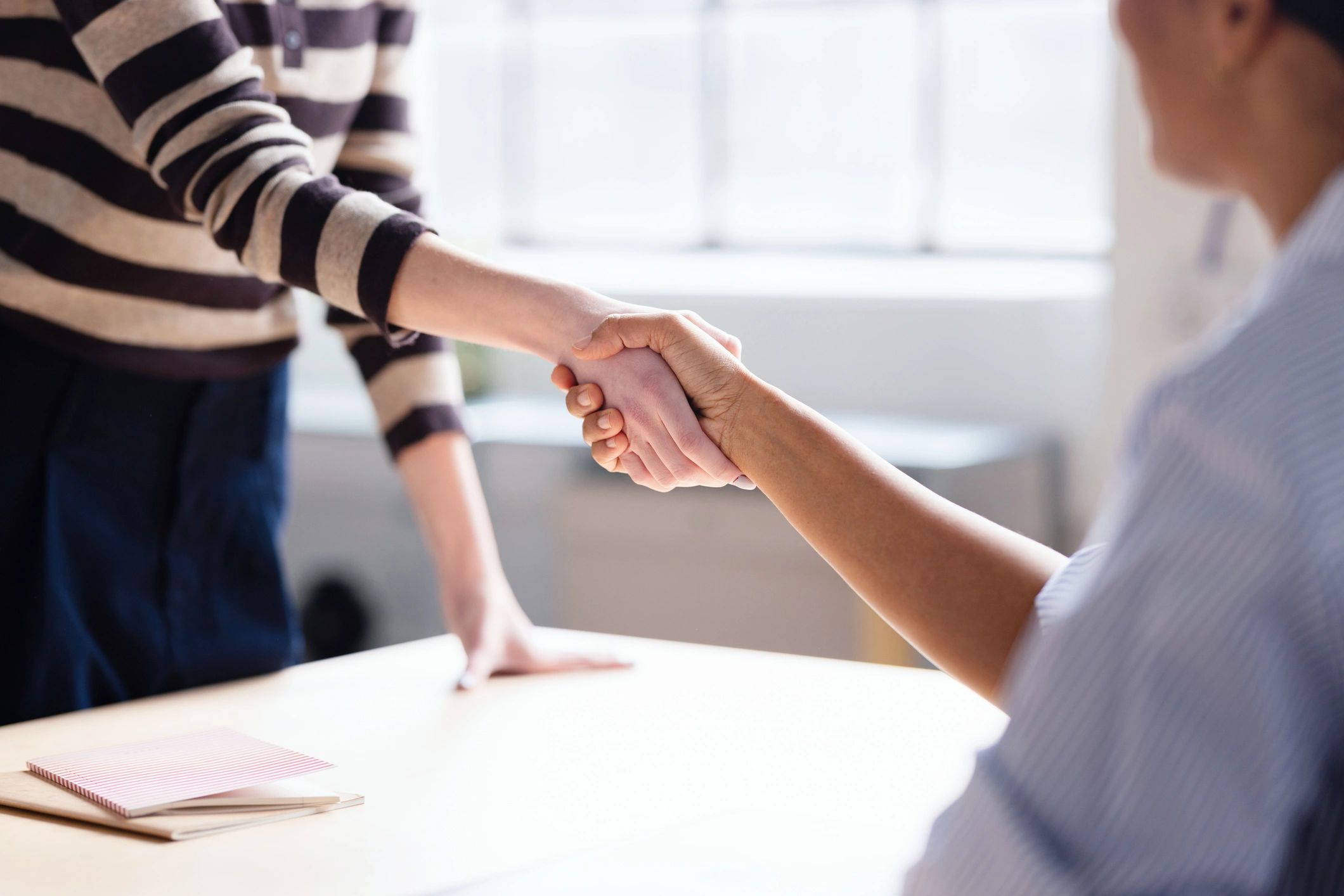 Business handshake representing trust and professional standards
